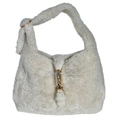 Gucci Jackie 1961 White Fluffy Shearling Bag Small The Gucci Jackie 1961 Black Small bag is a modern take on an iconic design. Crafted in white fluffy shearling and lined with leather, this "Teddy-like" rare super cute Jackie is your perfect accessory. CONDITION: NEVER WORN DETAILS: Brand: Gucci Model: Jackie 1961 Exterior Material: Shearling Exterior Color: White Interior Material: Suede Interior Color: White Hardware Color: Gold Size: Small Dimensions: Width: 28cm, Height: 18.5cm ACCESSORY: sh Gucci Marmont Super Mini, Shearling Bag, Gucci Jackie 1961, Marmont Super Mini, Gucci Marmont Bag, White Hardware, Gucci Brand, Gucci Outfits, Classic Flap Bag