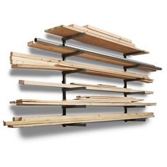 several wooden shelves are stacked on top of each other and one shelf is holding wood planks