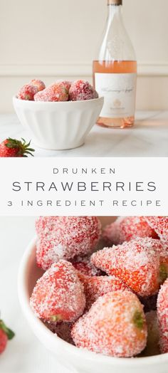 a white bowl filled with powdered sugar covered strawberries next to a bottle of wine