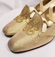 1960's gold lame' shoes with embroidered vamp and chunky heel Cute mid century modern pair of low heels. Size marked 7 B Measuresments: length ~ 9 1/2 inches, inside width ~ 2 3/4 inches, outside heel ~ 2 inches Sole reads: QualiCraft Worn 1x. These shoes are a ready to be worn! Buyer to pay all related shipping costs including insurance. Questions welcome. All Sales final Thank You CityVintage Retro Round Toe Heels For Wedding, Gold Slip-on Heels For Formal Occasions, Gold Slip-on Heels For Wedding, Gold Slip-on Heels For Evening, Retro Almond Toe Wedding Heels, Gold Round Toe Wedding Shoes For Party, Gold Wedding Shoes With Round Toe For Party, Gold Low-heel Wedding Shoes For Evening, Low Heel Gold Wedding Shoes For Evening