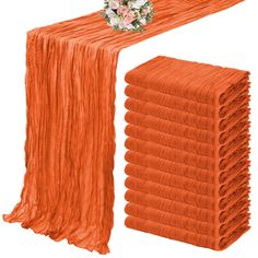 an orange table runner with flowers on it