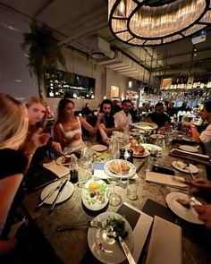 a group of people sitting around a dinner table