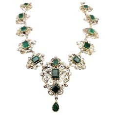 Transport yourself to a world of timeless beauty and sophistication with this extraordinary antique Victorian era graduated necklace. Adorned with mesmerizing emeralds and dazzling diamonds, this exquisite piece captures the essence of a bygone era. The necklace showcases a captivating arrangement of graduated emerald gemstones, carefully selected for their rich green color and exquisite clarity. Each emerald is meticulously set in an intricate scroll motif link crafted from lustrous 14K yellow Luxury Antique Jewelry With Rectangular Stone, Luxury Victorian Flower Pendant Jewelry, Luxury Vintage Rose Cut Diamond Necklace, Formal Emerald Necklaces With Single Cut Diamonds, Ceremonial Elegant Jeweled Necklaces, Vintage Diamond Gemstone Necklace, Vintage Diamond Necklace With Gemstones, Antique Green Jewelry With Single Cut Diamonds, Antique Emerald Jewelry For Formal Occasions