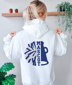 a woman wearing a white hoodie with the words made in detroit printed on it