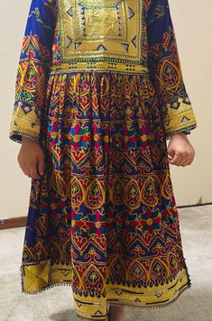 Afghan women's dress is a traditional handmade women dress called jawlie. It's made of Jawlie fabric, Zartar, rhinestones and jingle bells. Embellished Multicolor Embroidery Dress For Eid, Traditional Tunic Dresses For Festivals, Traditional Tunic Dress With Multicolor Embroidery, Festive Tunic Dress With Multicolor Embroidery, Traditional Festive Tunic Dresses, Eid Tunic Dress With Mirror Work, Eid Mirror Work Tunic Dress, Multicolor Embroidered Tunic Dress For Festivals, Traditional Embellished Multicolor Embroidered Dress