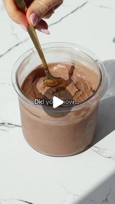 someone is dipping some kind of chocolate in a cup