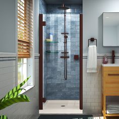 a bathroom with a walk in shower next to a sink and mirror on the wall