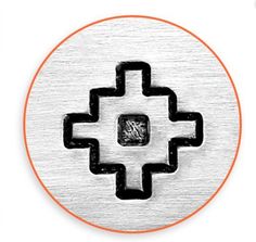 a metal button with an orange circle in the middle and black circles around it on a white background