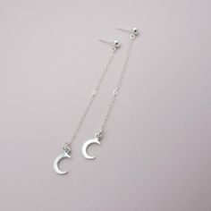 SOLID STERLING SILVER EARRINGSThese celestial earrings make a wonderful gift. The real sterling ear studs are adorned with a tiny moon that dangles elegantly on sterling silver chain. Comes in a gift box, perfect for gift giving. Total earring length is approximately 2 3/4 inches long. ALSO AVAILABLE IN A STAR DESIGN OR MOON/STAR COMBO Minimalist Moon Charm Drop Earrings, Minimalist Moon Shaped Single Earring, Dainty Moon Phase Earrings, Crescent Silver Earrings As Gift, Minimalist Crescent Earrings For Gift, Minimalist Crescent Earrings As Gift, Minimalist Moon Phase Earrings For Gifts, Minimalist Moon Phase Earrings As Gift, Minimalist Hypoallergenic Crescent Earrings