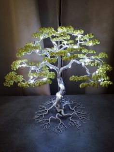 a tree that is sitting on a table with some lights in the shape of branches