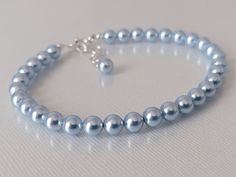 This is a RESERVED listing for Special Customer! Wedding Light Blue Blush Blue Colored Pearl Silver Dainty Bridal Bracelet. BRACELET is about 8 inches (20.3cm) long plus 1 inch extender chain. BRACELETS SECTION: https://www.etsy.com/shop/LanaChayka?ref=simple-shop-header-name&listing_id=892586384&sort_order=date_desc§ion_id=14226470 BRIDAL BRACELETS SECTION: https://www.etsy.com/shop/LanaChayka?ref=seller-platform-mcnav§ion_id=25839214 Classic and elegant, this dainty bracelet is perfect for wed Adjustable Blue Crystal Bracelet For Wedding, Elegant Adjustable Blue Pearl Bracelet, Elegant Blue Adjustable Pearl Bracelet, Light Blue Round Beads Jewelry For Wedding, Elegant Adjustable Light Blue Crystal Bracelet, Adjustable Blue Beaded Bracelets For Wedding, Elegant Light Blue Adjustable Crystal Bracelet, Adjustable Blue Pearl Bracelet For Wedding, Blue Round Beads Bracelet For Wedding