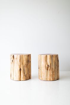 two wooden stools sitting on top of a white floor next to eachother