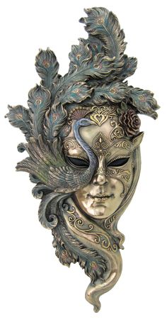 a mask with feathers on it and a woman's face painted in silver, blue and