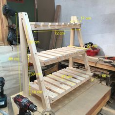 a wooden bed frame sitting on top of a workbench with measurements for it