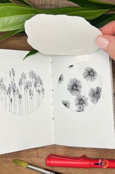 a person is drawing dandelions on paper