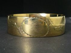 Cute victorian era bangle with engraved designs around the blank face. 19mm tall face. In great overall condition with no dents and very little wear. tested GF. Fits an approximate 7" wrist. Hinge and clasp works well. Victorian Etched Cuff Bracelet For Wedding, Antique Stamped Cuff Bracelet For Formal Occasions, Victorian Engraved Cuff Bracelet For Anniversary, Antique Engraved Cuff Bracelet For Formal Occasions, Antique Engraved Cuff Bracelet For Anniversary, Engraved Antique Cuff Bracelet For Anniversary, Antique Etched Cuff Bracelet For Formal Occasions, Antique Engraved Yellow Gold Cuff Bracelet, Vintage Yellow Gold Engraved Cuff Bracelet