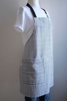 a mannequin wearing an apron made out of black and white striped fabric