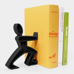 the bookend is next to two books in front of each other, one with a man's head on it