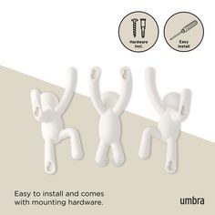 three white plastic figurines holding hands up in the air, with instructions on how to install and use them