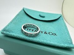 <p>Tiffany Co 18k White Gold Diamond Pierced Atlas Band Ring Roman Numeral Size 4.5. </p><br /><p>Markings: T&Co AU 750 </p><p>Stones: Diamonds - melee x4</p><p>Size: 4.5</p><br /><p>Tiffany pouch and box are included </p> Designer Hallmarked White Gold Rings, Designer White Gold Rings Hallmarked, Designer White Gold Hallmarked Rings, Designer Hallmarked Jewelry For Collectors, Designer Oval White Gold Ring, Designer White Gold Rings For Formal Events, Designer Formal Rings, Designer 14k Stamped Formal Jewelry, Designer Sterling Silver Hallmarked Rings