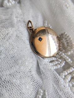 Beautiful antique gold plated locket with a small stone in dark blue glass paste. Good overall antique condition, some wear and tear consistant with the age of the jewel. The plating is gone in places, especially on the sides. Size: about 2.3 cm in diameter. Possible colour variations due to the light. Elegant Antique Finish Locket Necklace, Antique Sapphire Jewelry In 14k Gold, Victorian Locket Necklace With Antique Finish, Antique 14k Gold Sapphire Jewelry, Antique Blue Locket Jewelry, Bronze Antique Finish Locket Necklace, Victorian Blue Locket Jewelry, Blue Victorian Locket Jewelry, Antique Adjustable Locket