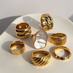 We're all about the bold statements this season, that's why we made you these gold signet rings to add to your jewelry rotation. Wear any of these alone or build your own stack for a perfect trendy look.• S P E C I F I C A T I O N •Finish: 18K gold, waterproof Chunky Gold Jewelry, Bold Statement Jewelry, Ringe Gold, Dope Jewelry, Chunky Jewelry, Couple Jewelry, Jewelry Fashion Trends, Chunky Rings, Classy Jewelry