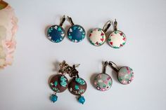 six pairs of earrings with flowers on them