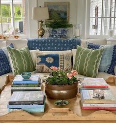 a living room filled with lots of furniture and books on top of a coffee table