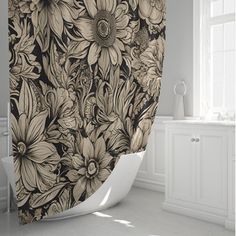 a black and white floral shower curtain in a bathroom