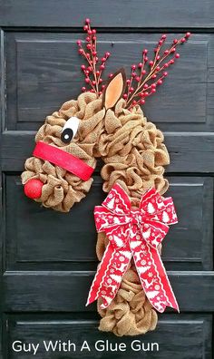 a door hanger made out of burlocks with a reindeer head on it