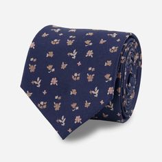 Allow us to introduce our Falling Florals Tie, a charming men's necktie that embodies sophistication and style with its bestselling navy blue color and geo-like floral pattern. | Men's Tie Bar: Falling Florals Tie - Modern, In Navy, Silk, Floral Blue Dapper Suit And Tie Accessories For Summer, Dapper Blue Suit And Tie Accessories For Summer, Blue Neckwear For Business In Summer, Business Neckwear With Ties For Summer, Blue Cotton Tie For Formal Occasions, Blue Formal Neckwear For Spring, Blue Neckwear For Formal Spring Occasions, Blue Neckwear For Formal Occasions In Spring, Blue Floral Print Suit And Tie Accessories For Business