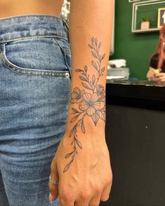 a woman with a flower tattoo on her arm