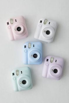 four different colored cameras sitting next to each other