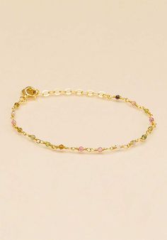 Vibrant in colour, this Tourmaline Beaded Gold Plated Bracelet from UNE A UNE is crafted from tourmaline beads colours and separated by gold-plated chain. It is finished with a logo-engraved charm and can be easily adjusted for the perfect fit. Slip it on and stack it high. Elegant Gold Tourmaline Bracelets, Gold Spiritual Beaded Chain Bracelet, Dainty Gold Tourmaline Jewelry, Gold Tourmaline Bracelet Jewelry, Gold Tourmaline Gemstone Bracelets, Gold Tourmaline Bracelet, Beaded Tourmaline Bracelets As A Gift, It Is Finished, Tourmaline Beads