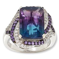 Colleen Lopez Sterling Silver Bi-Color Fluorite and Multigem Ring  Flaunt your unique style when you accessorize with this captivating ring design. The sterling silver piece features a natural, bi-color fluorite stone surrounded by complementary purple amethyst and the diamond-like sparkle of white zircons. The result is an elegant, distinctive piece you'll be wearing for many years to come!       Approx. 7/16"L x 7/16"W; shank 3/16"W     Stamped .925     Ring has emerald-cut, bi-color fluorite stone prong set in center of swirl design     Swirl-style frame and split shoulders lined with round white zircons and purple amethyst stones     Finished undergallery   Stone Information       All sizes and weights approximate     Total Carat Weight: 9.04ct     Bi-Color (Green/Purple) Fluorite - Em Alexis Bittar Jewelry, Fluorite Stone, Amethyst Stones, Purple Fluorite, Color Bands, 925 Ring, Alexis Bittar, Blue Jewelry, Swirl Design