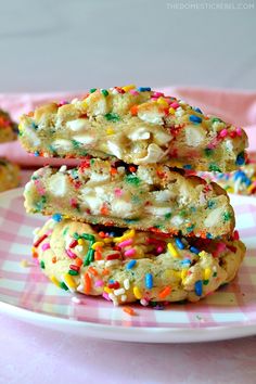 three cookies stacked on top of each other with sprinkles and white chocolate