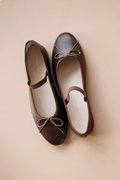 Soft ballet flat in chocolate brown Italian glove calf leather with an elastic bridge strap and bow detail. Features a padded footbed with gold stamped logo and an almond toe. Ballet Flats For Women, Movie Fits, Soft Ballet Flats, Brown Ballet Flats, Cutest Shoes, Brown Leather Flats, Xmas List, Chocolate Leather, Cute Flats