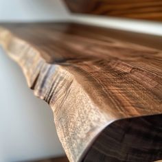 a close up view of a wooden bench with wood graining on the top and bottom