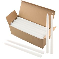 white candles in a cardboard box on a white background