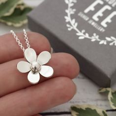 POSTAL DELAYS ARE COMMON DURING DECEMBER AND SADLY I CAN NOT GUARANTEE YOUR ORDER WILL ARRIVE IN TIME FOR CHRISTMAS.    This pretty sterling silver flower pendant necklace has been designed and is handmade by me, completely from scratch in my Sussex UK workshop using traditional silversmithing techniques.   First I create a design which I then transfer to silver sheet.   Then begins the process of carefully piercing out the flower with a very fine saw blade.  After, follows lots of filing and refining until I'm happy with the shape before doming and topping off with a hand-forged silver ball.   The flower pendant measures approximately 1.9cm at its widest point and is supplied on a lovely sterling silver mini rolo chain. Matching flower dangle earrings are available here: https://etsy.me/2 Flower Pendant Necklace For Mother's Day, Silver Flower Necklace For Anniversary, Anniversary Flower Charm Necklace, Handmade Dainty Sterling Silver Flower Necklace, Handmade Silver Flower-shaped Necklace, Delicate Silver Flower Charm Necklace, Sterling Silver Flower Charm Necklace For Mom, Handmade Silver Flower Necklace, Silver Delicate Flower Charm Necklace