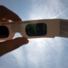 a person holding up a white object in the sky