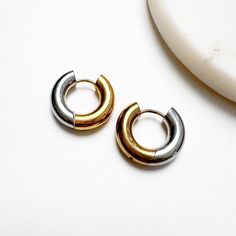 Part Of Our B+B Collection, These Cute Stainless Steel Huggie-Style Mini Hoops Are A Sleek, Modern Update Of A Basic Essential. With A Mix Of Gold And Silver-Toned Metals, These Hypoallergenic And Water-Resistant Earrings Create The Perfect Neutral Earrings That Pair Well With Virtually Any Outfit. Features A Latch-Back Closure. Our Xena Mini Hoops Are Reversible And Can Be Worn With Gold In Front Or Worn Backward With Silver In Front. D E T A I L S __________________________________________ Sta Two Tone Earrings, Two Tone Jewelry, Neutral Earrings, Boutique Jewelry, Silver Hoops, Gold And Silver, Silver Gold, Convertible, Two Tone