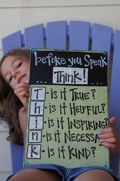 a woman holding up a sign that says, before you speak think is it true?