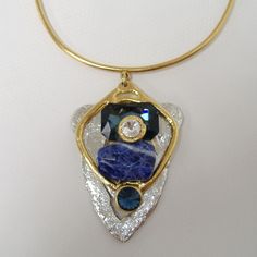 Large Chunky Blue & Crystal Pendant Necklace By J. Jansen. Unique Necklace In Clear Crystal & Shades Of Blue Colored Semi-Precious Stones. Plated In 24 Kt Gold & A Non-Tarnish Silver Finish. Adjustable Length From Approx. 14" To 16". New With Tag. 100 407 263 Modern Blue Pendant Jewelry, Modern Blue Metal Necklaces, Modern Blue Metal Necklace, Modern Blue Necklaces For Parties, Luxury Blue Jeweled Necklaces, Modern Blue Necklace For Party, Modern Blue Gemstone Necklace, Modern Blue Metal Jewelry, Elegant Blue Crystal Necklace With Gemstone Accents