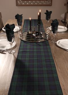 Make your holiday table stand out with the classic Black Watch tartan table runner. Its timeless navy, green, and black plaid design adds a sophisticated touch to your festive table setting, while also creating a cozy, relaxed feel for your country home. Perfect as a striking accent for your holiday dishes or as a stylish runner on your mantle, this versatile piece brings elegance and warmth to any décor. The tartan table runner is made of polyviscose fabric with a coordinating rolled hem edging Scottish Christmas Table Settings, Christmas Tartan Table Settings, Classy Christmas Party Ideas, Black Watch Tartan Christmas, Black Watch Plaid Christmas, Tartan Christmas Decorations, Plaid Table Runner, Air Force Families, Festive Table Setting