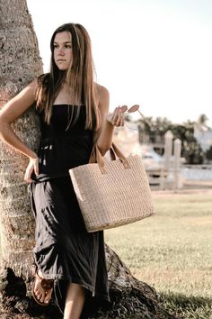 This airy, straw tote bag is finished with natural leather handles and a classic linen lining. Versatile and stylish, it's the perfect partner for airy dresses, summer prints or white denim. Content:- Straw- Leather - Linen Lining- Imported Size:- Width: 18.25" - Height: 12"- Depth: 6.59"- Handle Drop: 4.5" Chic Handwoven Natural Fiber Bucket Bag, Chic Summer Bags Made Of Natural Fiber, Chic Beach Bag Made Of Natural Fiber, Elegant Natural Straw Tote Bag, Chic Double Handle Straw Bag, Chic Woven Straw Bag With Double Handles, Summer Beige Straw Bag For Day Out, Chic Beach Bags With Bamboo Handle, Chic Bags With Leather Handles For Day Out