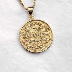 men's circle korean dragon necklace pendant 3 made in real 14k solid gold or real 18k solid gold two dragons with exquisite details is main on a circle pendant. we depicted dragons, ocean waves and clouds as korean style. - model wears a 2.1mm 60cm chain. - the pendant diameter is 26.5mm. - materials: real 14k solid gold, real 18k solid gold - free shipping on all orders! - designed by carre d'or - made in south korea 14k gold dragon pendant necklace 3 weight pendant only 7.68g (±3%) with a 2.1mm chain 42cm 13.64g (±3%) with a 2.4mm chain 42cm 15.51g (±3%) with a 3.0mm chain 42cm 19.26g (±3%) 18k gold dragon pendant necklace 3 weight pendant only 9.15g (±3%) with a 2.1mm chain 42cm 16.19g (±3%) with a 2.4mm chain 42cm 18.40g (±3%) with a 3.0mm chain 42cm 22.82g (±3%) Gold Dragon Design Jewelry, Gold Jewelry With Dragon Design, Gold Round Jewelry With Dragon Design, Gold Dragon Design Round Pendant Jewelry, Gold Round Pendant With Dragon Design, Korean Dragon, Men's Necklace Gold, Gold Dragon, Dragon Necklace