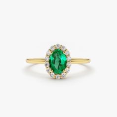 Emerald Ring / 14k Classic Oval Cut Emerald Ring with Surrounding Diamonds / Natural Emerald Ring in 14k Solid Gold / Mothers Day Gift Item Features * Made to Order. * Gold KT: 14K * Custom Gold Color: Rose Gold, Yellow Gold, White Gold * Number of Emeralds and Size : 1 Oval Emerald 6x4MM in Size * Number of Diamonds:  14 Round diamonds 1.30MM in Size * Total Emerald CTW: 0.40ctw * Total Diamond CTW: 0.15ctw * Diamond Color Clarity: G Color SI Clarity * Setting Type: Prong * Band Width: 1.25mm * Ready to Ship in 7-10 Business Days ▶ See more of our Emerald Jewelry - https://etsy.me/3QCyZBQ ▶ See our storefront here - http://etsy.me/2lUcVnH  ▶ All store sections here * Diamond Rings - http://etsy.me/2lwKUl8 * Diamond Earrings - http://etsy.me/2lyqVBP * Diamond Necklace - http://etsy.me/2mqa 14k Yellow Gold Cluster Ring With Oval Shape, 14k Gold Emerald-cut Halo Cluster Ring, 14k Gold Emerald-cut Cluster Ring With Halo Design, 14k Gold Emerald Cut Cluster Ring With Halo Design, 14k Gold Emerald Cut Halo Cluster Ring, Classic Yellow Gold Emerald Ring With Halo, 14k Gold Emerald Cut Halo Setting Ring, Classic Emerald Ring With Halo, Classic Round Emerald Ring With Halo