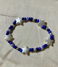 Cute blue and white beaded bracelet with star beads. These are high quality handmade bracelets. They are made with an very stretchy and strong elastic string so will fit lots of sizes. They are around 6.75 inches. Please note that each braclet will have a very similar beading pattern but not exactly identical. Braclete Pattern Clay Beads, Bracelet Patterns Beads, Bracelet Clay, Clay Beaded Bracelet, White Beaded Bracelet, Star Beads, Cute Bracelet, Bracelet Pearl, Business Idea