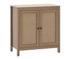 a cabinet with two doors and wicker panels on the front, one door open